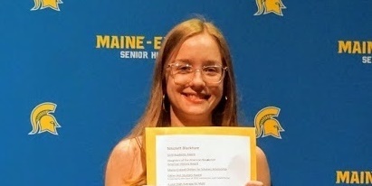 Female student holding award